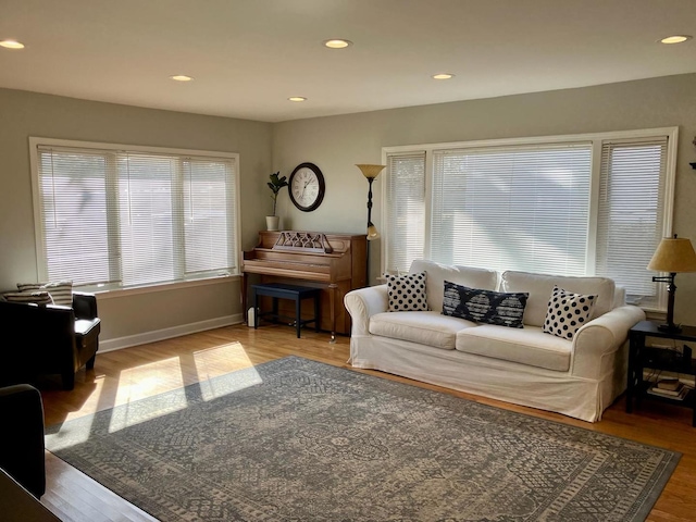 living room with recessed lighting, baseboards, and wood finished floors