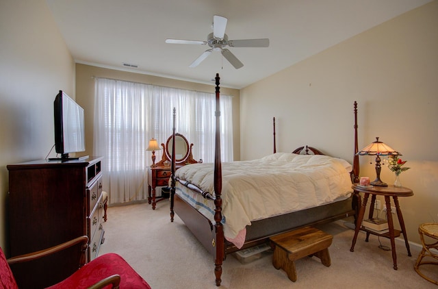 bedroom featuring visible vents, light colored carpet, and ceiling fan