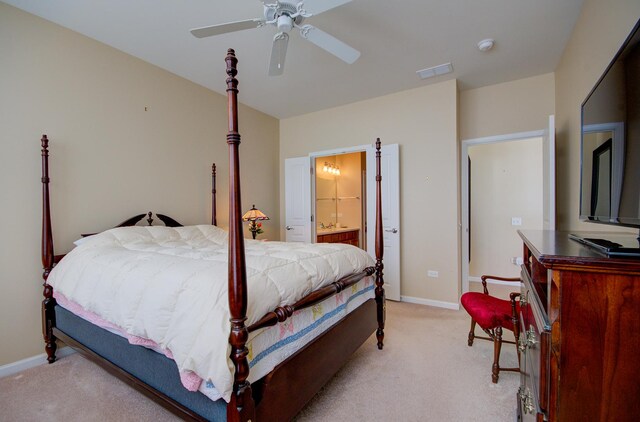 bedroom with visible vents, ceiling fan, baseboards, light carpet, and ensuite bath