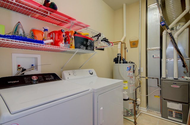 laundry room featuring light tile patterned floors, heating unit, laundry area, washer and dryer, and gas water heater