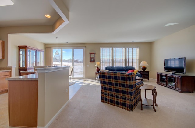 living room with recessed lighting, baseboards, light carpet, and a healthy amount of sunlight