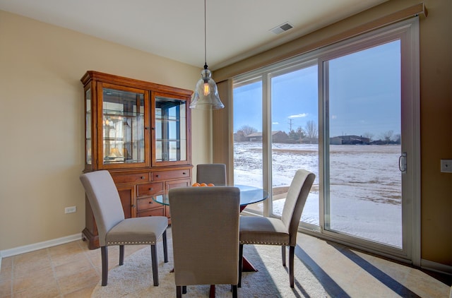 dining space featuring baseboards and visible vents