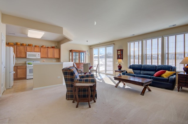 living room featuring visible vents and light carpet