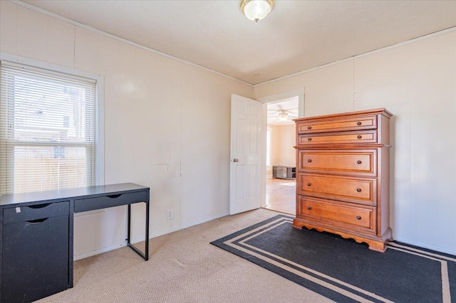 home office featuring light carpet and crown molding