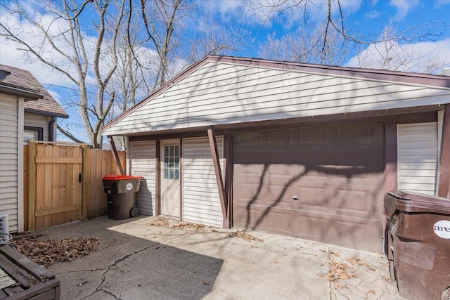 detached garage featuring fence