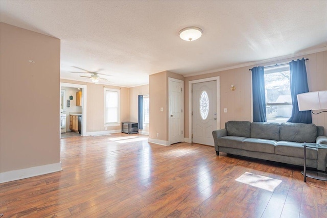 living room featuring ornamental molding, a wealth of natural light, and hardwood / wood-style floors