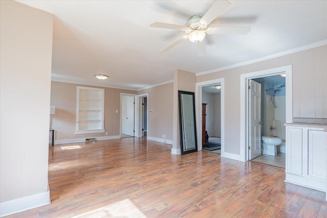 interior space featuring ceiling fan, baseboards, built in features, light wood-type flooring, and crown molding