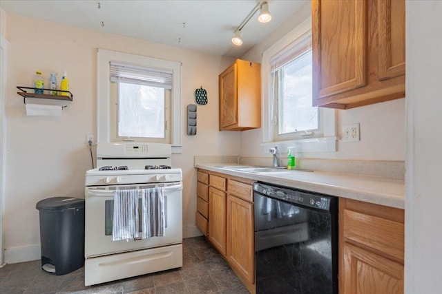 kitchen with white gas range, light countertops, a sink, dishwasher, and baseboards