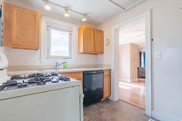 kitchen with white range with gas stovetop, a sink, baseboards, light countertops, and dishwasher