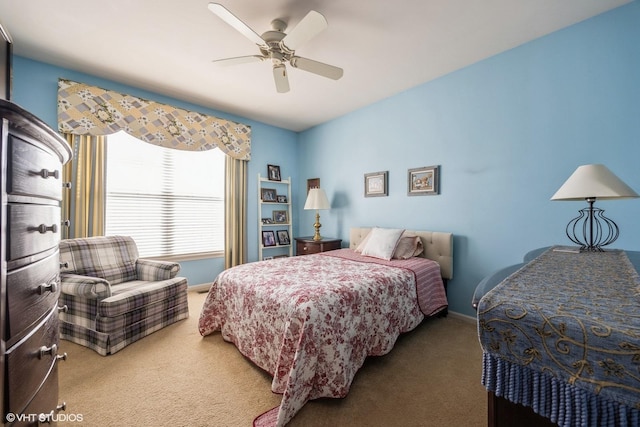 carpeted bedroom featuring a ceiling fan and baseboards