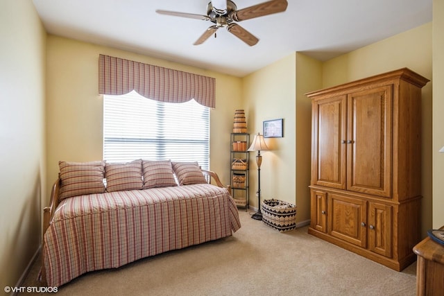 bedroom featuring baseboards, a ceiling fan, and light colored carpet