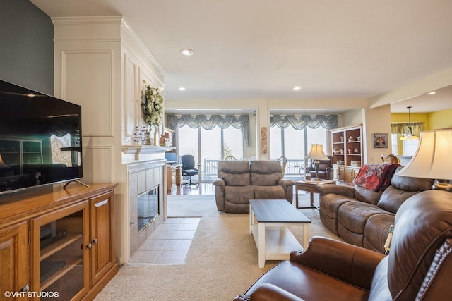 living room featuring recessed lighting, a fireplace, and light colored carpet