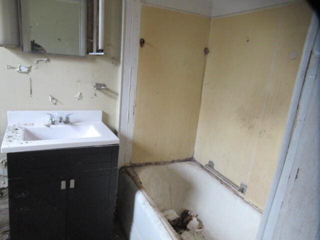 bathroom featuring vanity and a tub