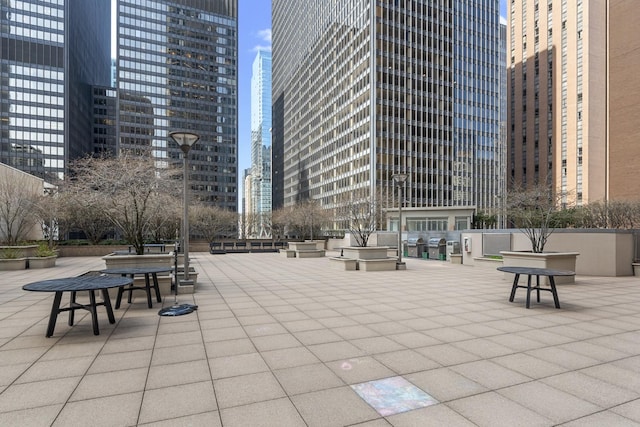 view of community with a patio and a view of city