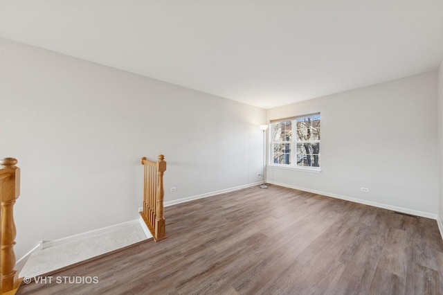 empty room featuring wood finished floors and baseboards