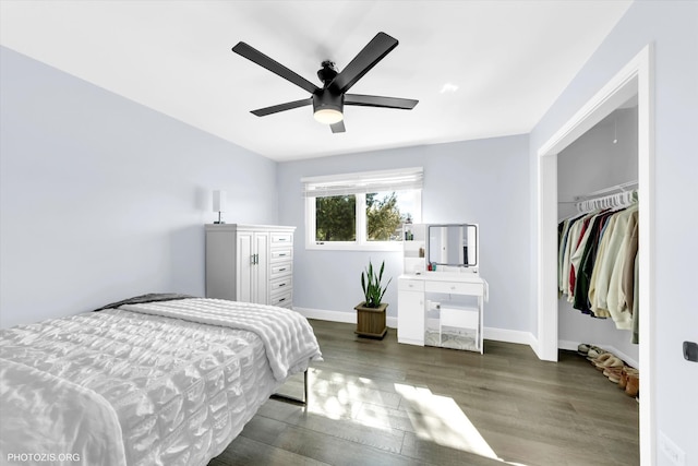 bedroom with a ceiling fan, baseboards, and wood finished floors