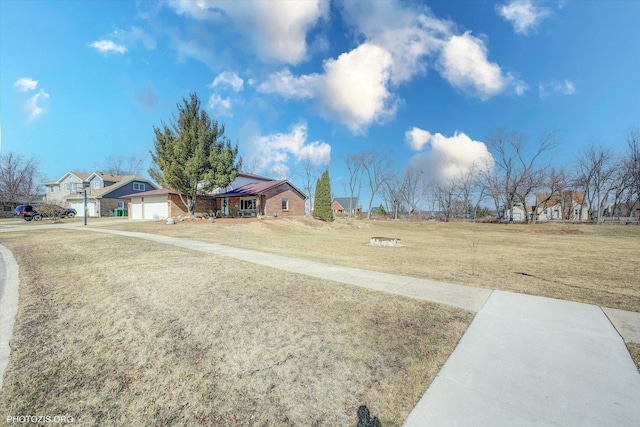 view of yard featuring a garage and driveway