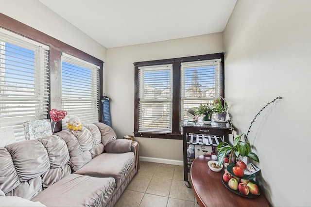 living room featuring light tile patterned floors and baseboards