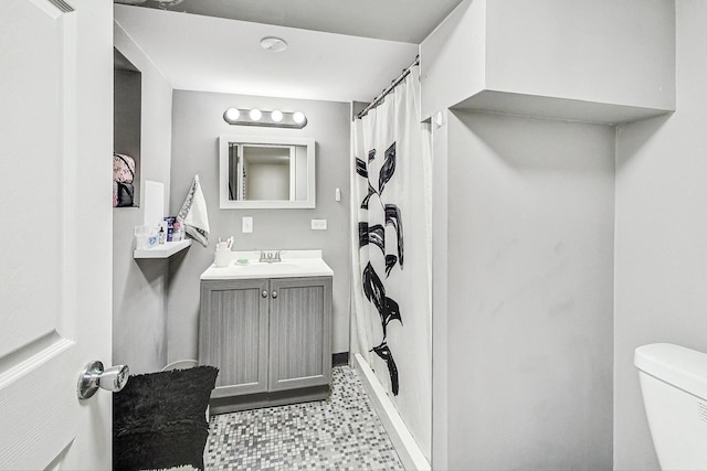 bathroom featuring toilet, tile patterned floors, and vanity