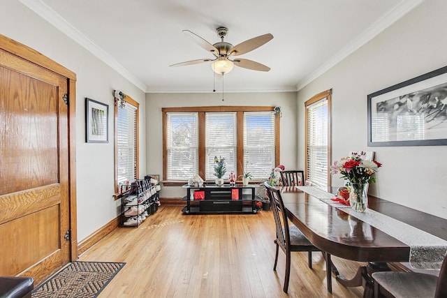 dining space featuring ornamental molding, light wood finished floors, a ceiling fan, and baseboards