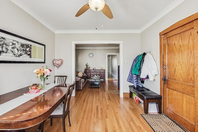 interior space with light wood-style floors, ornamental molding, baseboards, and a ceiling fan