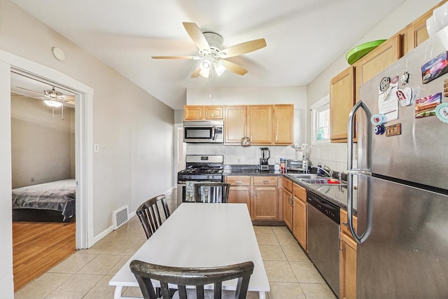 kitchen featuring light tile patterned floors, tasteful backsplash, visible vents, and stainless steel appliances