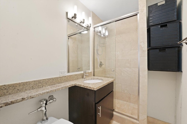 bathroom with a shower stall and vanity