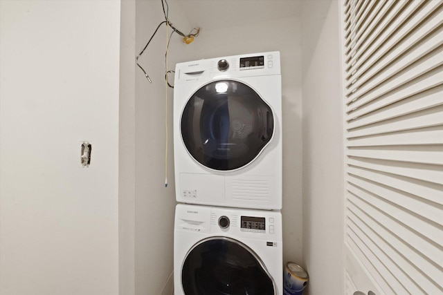 laundry room featuring stacked washer and clothes dryer and laundry area