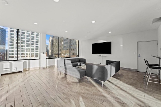 living room with recessed lighting and wood tiled floor