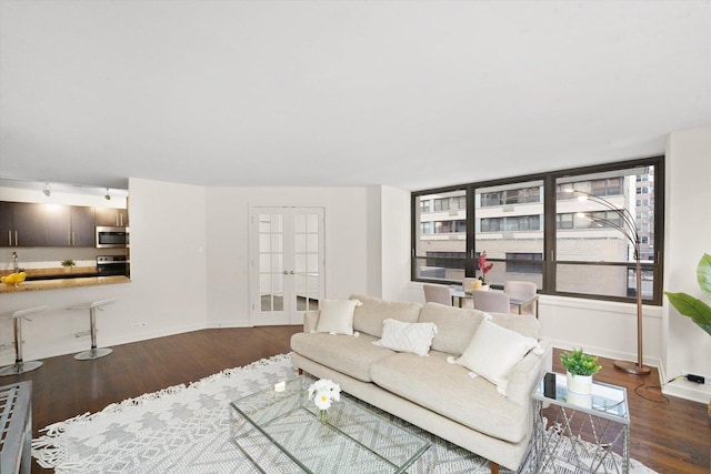 living room with french doors, wood finished floors, and baseboards