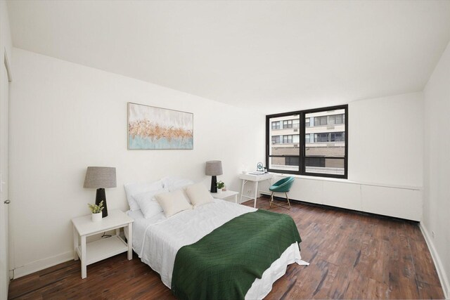 bedroom featuring baseboards and wood finished floors