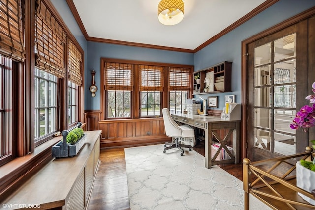 home office with ornamental molding, wood finished floors, and wainscoting