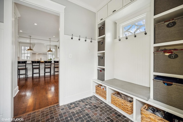 mudroom with ornamental molding, dark wood-type flooring, and recessed lighting