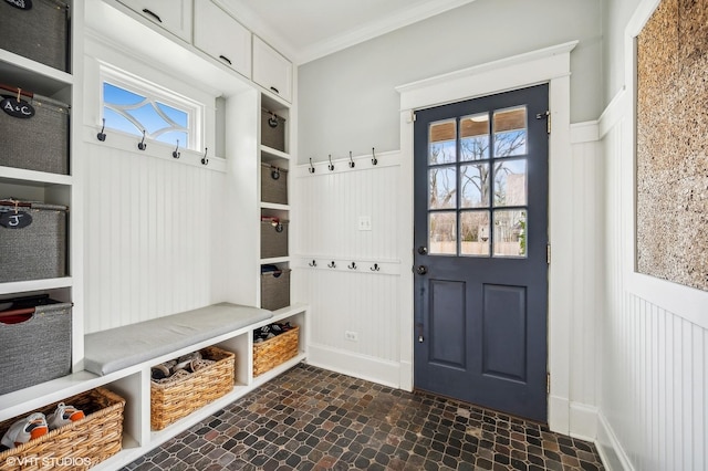 mudroom with ornamental molding, wainscoting, and a healthy amount of sunlight