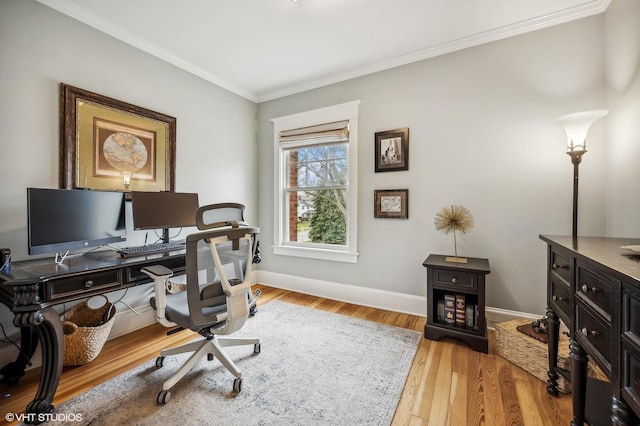 office space featuring baseboards, ornamental molding, and wood finished floors