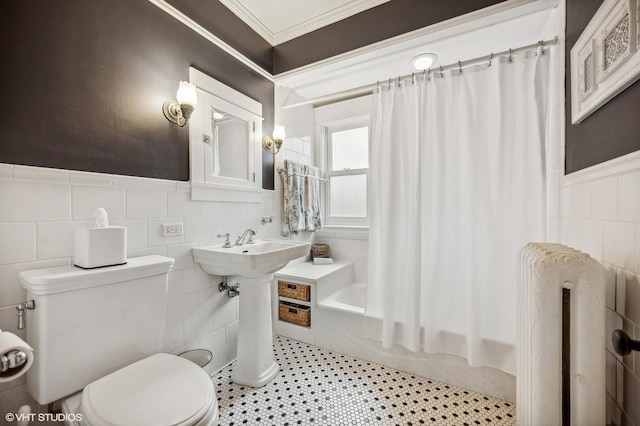 bathroom with wainscoting, toilet, radiator heating unit, ornamental molding, and tile walls