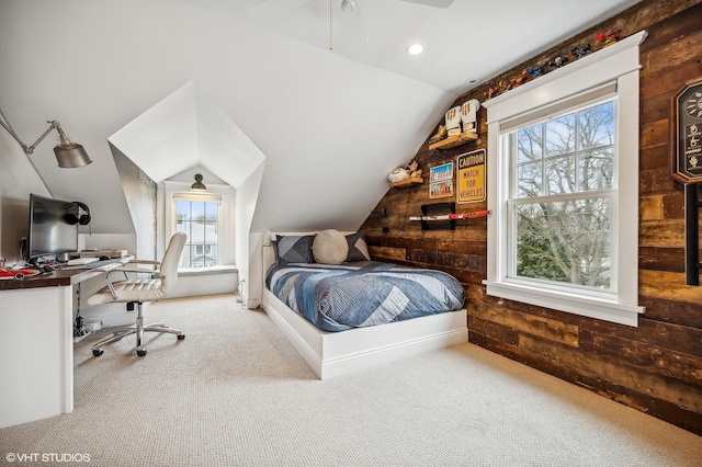 bedroom featuring carpet floors, recessed lighting, vaulted ceiling, and wooden walls