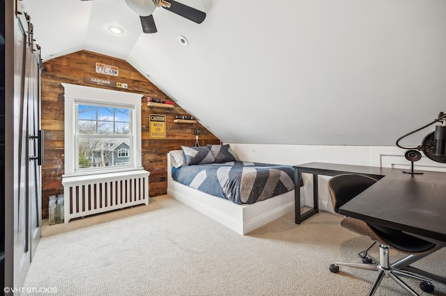 carpeted bedroom featuring radiator, wood walls, vaulted ceiling, and a ceiling fan