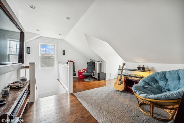 sitting room featuring recessed lighting, vaulted ceiling, wood finished floors, and an upstairs landing