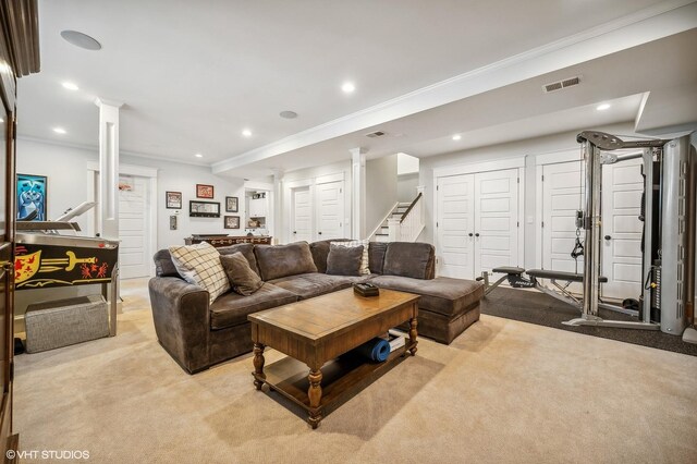 living room featuring decorative columns, visible vents, light colored carpet, stairway, and crown molding