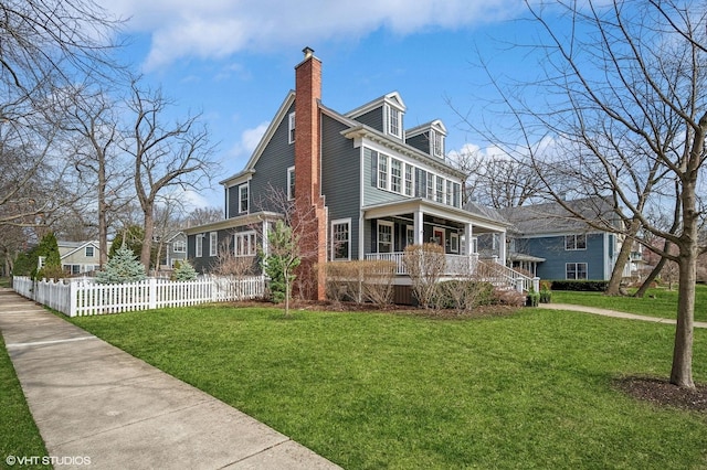 view of home's exterior with covered porch, a chimney, fence, and a yard