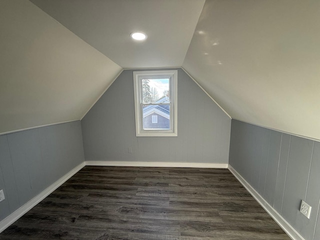 bonus room with vaulted ceiling, baseboards, and dark wood finished floors