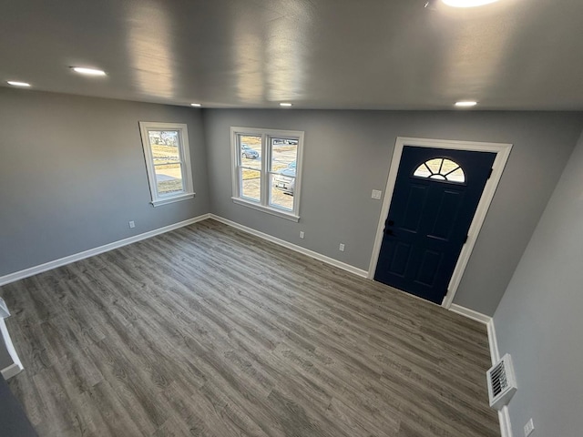 entryway featuring visible vents, baseboards, and dark wood-style flooring