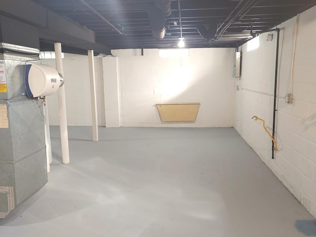 unfinished basement featuring electric panel and heating unit