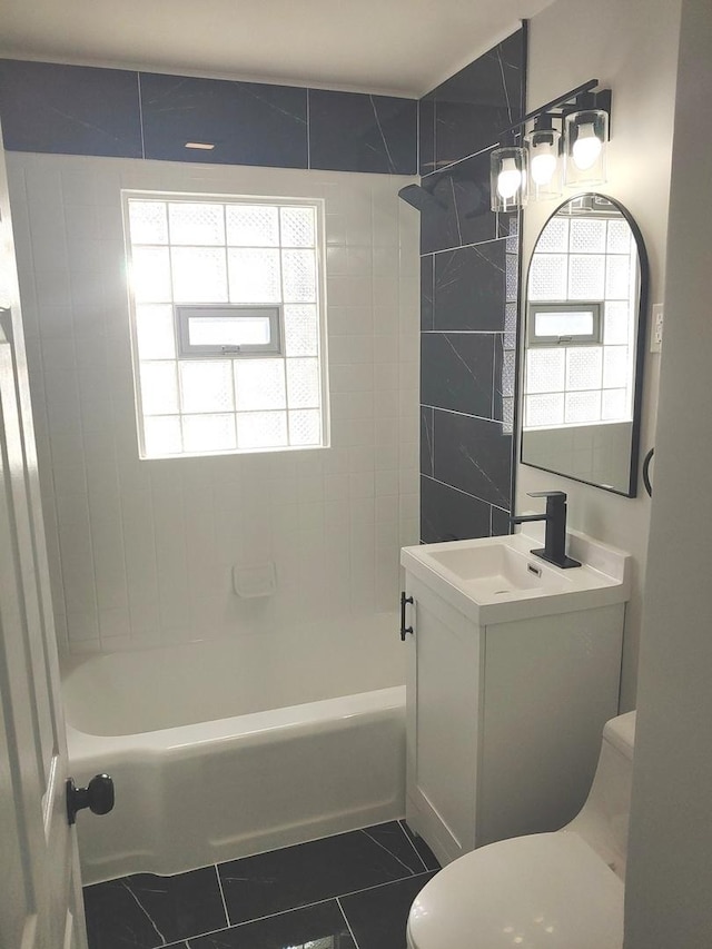 full bath with tub / shower combination, vanity, toilet, and tile patterned floors