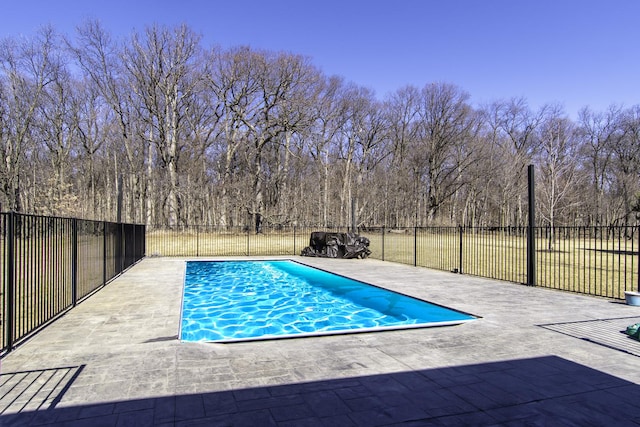 view of swimming pool featuring a patio area, a fenced in pool, and fence