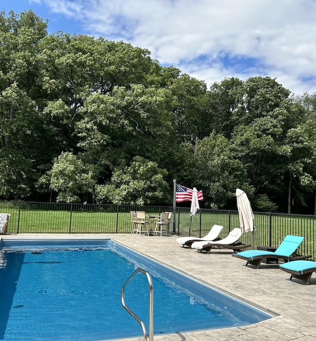 pool featuring a yard and fence