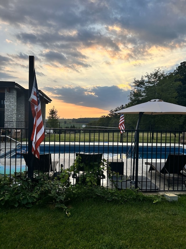 view of swimming pool featuring a patio area, a swimming pool, and fence