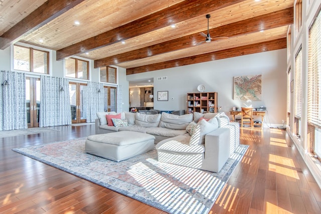 living room with beamed ceiling, french doors, visible vents, and wood-type flooring