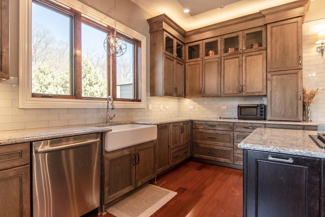 kitchen featuring dark wood-style floors, a sink, glass insert cabinets, and stainless steel dishwasher